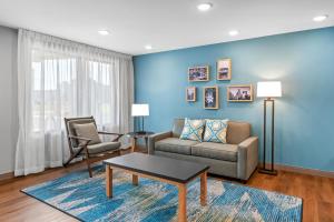 a living room with a couch and a table at WoodSpring Suites Charlotte Northlake in Charlotte