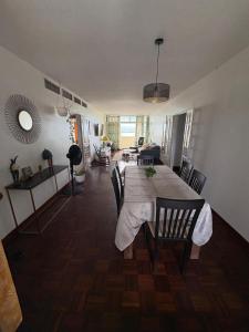 a dining room table with chairs and a living room at Oasis du 7e ciel in Pointe-à-Pitre