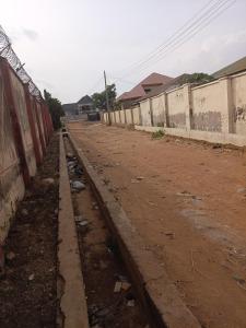 an empty dirt road next to a fence at Limelight Apartment and suites in Oko Erin