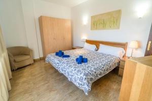 a bedroom with a bed with blue candles on it at Edificio Prieto VIV 2C in Puerto del Rosario +34 photos