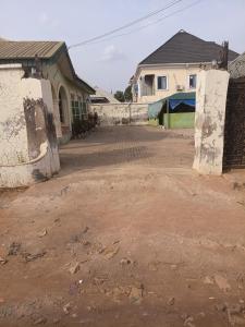 an empty dirt road in front of a house at Limelight Apartment and suites in Oko Erin