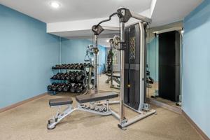 a fitness room with a gym with weights at WoodSpring Suites Charlotte Northlake in Charlotte