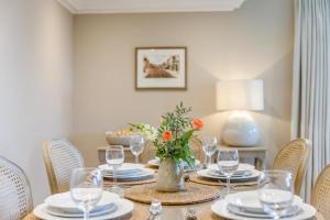a table with plates and glasses and a vase with flowers at 2 Bed in Ludlow oc-p31882 in Ludlow