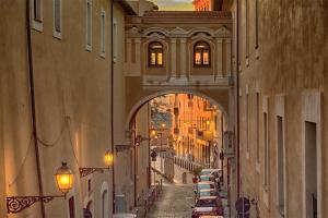 an archway over a street with cars parked on the street at Captain's Lodge in Civitavecchia