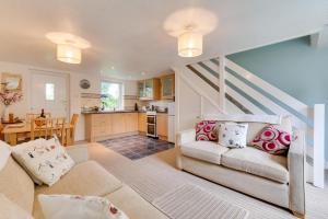a living room with a couch and a kitchen at 2 Bed in Penzance oc-pc467 in Gulval