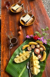a wooden table with a plate of food on it at La Capanna Sumatra Ecovillage in Timbanglawang