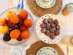 a table with a bowl of fruit and a bowl of oranges at Dimora Sorelle del Mar - Polignano a Mare in Polignano a Mare +37 photos