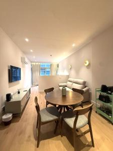 a living room with a table and a couch at Madrid Modern Studio with Terrace & Parking in Madrid