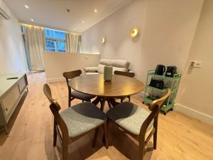 a dining room with a table and chairs at Madrid Modern Studio with Terrace & Parking in Madrid