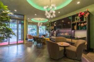 a dining room with a table and chairs at Leonardo Hotel Antwerpen in Antwerp