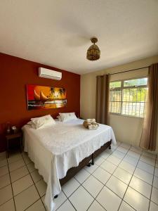 a bedroom with a bed with a stuffed animal on it at Residencial Dragão in Fortaleza