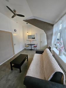 a living room with a couch and a table at Die kurPark Eule in Mölln