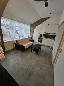 a large living room with a couch and a kitchen at Die kurPark Eule in Mölln