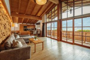 a living room with a couch and a table at Berg- & Seeblick Pfefferbauer in Zell am See