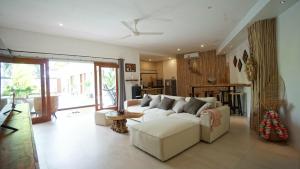 a living room with a white couch and a table at Villa Fireflies in Darmasaba