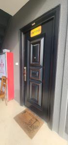 a black door with a sign on top of it at Capital Transit Hub in Port Moresby