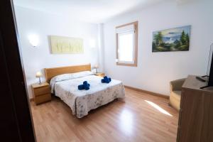 a bedroom with a bed with blue pillows on it at Edificio Prieto VIV 2E in Puerto del Rosario