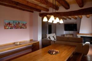 a living room with a table and a couch at Masia Lledó de Trascastell in Balsareny