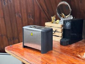 a toaster sitting on top of a wooden table at Igloo-Dome by a River - Sky Sighting - Glamping in Litli-Árskógssandur