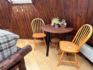 a room with a table and chairs and a bed at Igloo-Dome by a River - Sky Sighting - Glamping in Litli-Árskógssandur