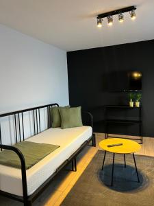 a bed and a table in a room at Różana City Apartaments in Kutno