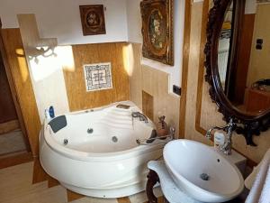 a bathroom with a tub and a sink and a mirror at Casa vacanze Felicitas in Martone +137 photos