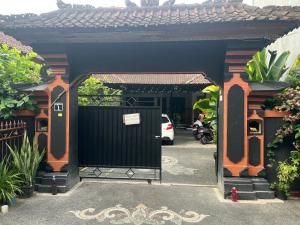 an entrance to a building with a black gate at D nux House in Ngurah Rai International Airport