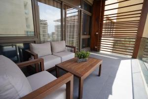 a balcony with a couch and a coffee table at Heaven Prestige Hotel in Jounieh