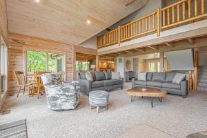 a living room with couches and a staircase in a house at Alpine Adventure in McHenry