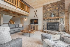 a living room with a couch and a fireplace at Alpine Adventure in McHenry