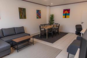 a living room with a couch and a table and chairs at Kaiserviertel Gastromeile, City, Messe & Stadionnah in Dortmund +31 photos