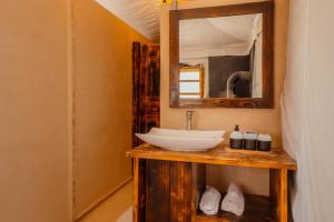 a bathroom with a sink and a mirror at Oxygen Lodge Agafay in El Karia +62 photos