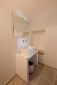 a bathroom with a white sink and a mirror at Janela Blue Civico 35 in Otranto +7 photos