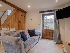 a living room with a couch and a flat screen tv at Rose Cottage in West Buckland