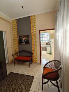 a living room with a couch and a chair at Sereny Stone Palace in Rondonópolis +21 photos