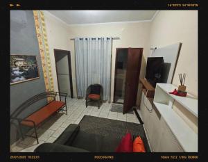 a living room with a couch and a tv at Sereny Stone Palace in Rondonópolis