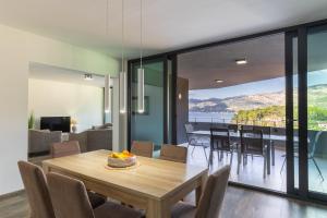 a dining room and living room with a table and chairs at Korcula Luxury Apartments in Korčula