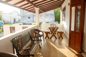a patio with two chairs and a table on a balcony at The Teak Ambalangoda in Ambalangoda +34 photos