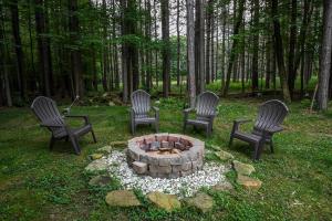 a group of four chairs around a fire pit at Howling Wolf Den in Oakland