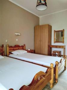 a bedroom with a bed and a cabinet in it at NEFELI House in Lefkimmi