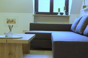 a living room with a couch and a coffee table at Ferienwohnung 1 ANNA IFF in Würzburg