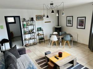 a living room with a couch and a table at Vazaha grand et bel appartement classé 3 étoiles in Lavelanet +18 photos