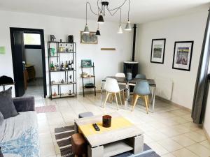 a living room with a couch and a table at Vazaha grand et bel appartement classé 3 étoiles in Lavelanet