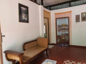 a living room with a couch and a chair at Lulu s dream cafe in Welata