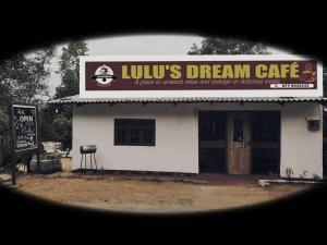 a building with a dream cafe with a sign on it at Lulu s dream cafe in Welata