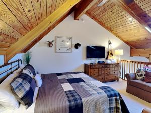 a bedroom with a bed and a tv and a couch at Sunplace 02 in McHenry
