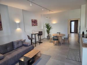 a living room with a couch and a table at Karatza's suite 2 in Chios