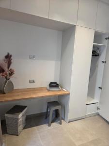 a room with a desk and a stool at Karatza's suite 2 in Chios