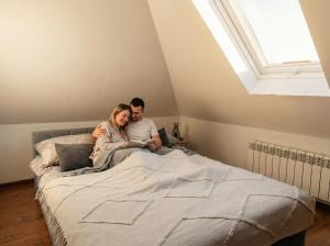 a man and a woman sitting on a bed at Fotuso House in Majdany Wielkie +54 photos