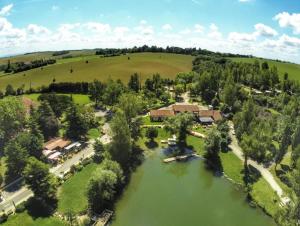 an aerial view of a house with a lake at ZEcamping 3 dog friendly avec piscine au bord du lac de la Thésauque in Nailloux